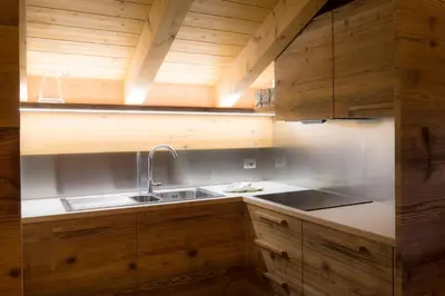 a kitchen with a sink and wooden cabinets at Pigala Al Drit in Rivamonte