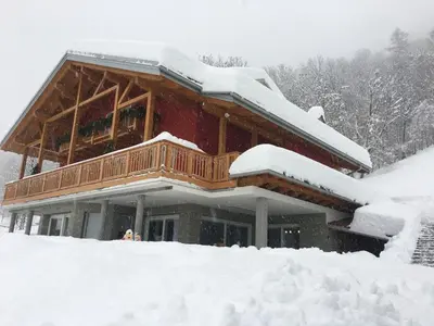 a large wooden house covered in snow at Pigala Al Drit in Rivamonte