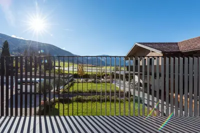 a building with a balcony on the side of it at Luxury Chalet Trumpfer in Riscone