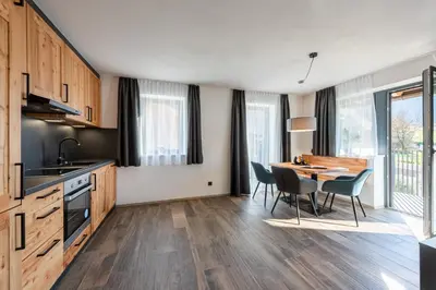a kitchen with a table and chairs in a room at Luxury Chalet Trumpfer in Riscone