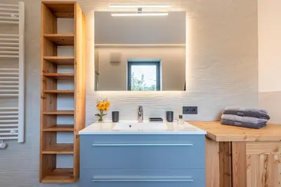 a bathroom with a sink and a mirror at Luxury Chalet Trumpfer in Riscone