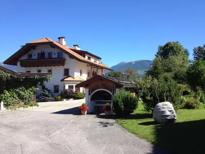 a large house with a driveway in front of it at Residence Untermoarhof in Brunico