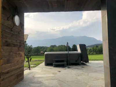 a couch sitting on a patio with a view at Residence Untermoarhof in Brunico