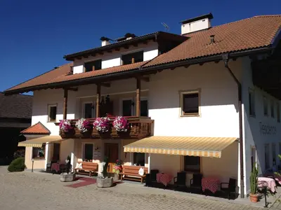 a large white building with flowers on the balcony at Residence Untermoarhof in Brunico
