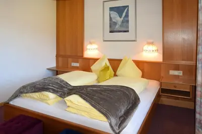 a bedroom with a bed with a blanket on it at Residence Untermoarhof in Brunico