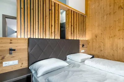 a bedroom with a bed with two pillows on it at MONTARA living mountain air in Terento