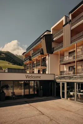 a building with a welcome sign in front of it at MONTARA living mountain air in Terento