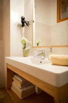 a bathroom with a white sink and a mirror at Obereggerhof - Urlaub auf dem Bauernhof - Ferienwohnungen - Gitschberg Jochtal - Rio di Pusteria in Valles