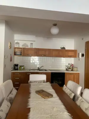 a kitchen with a wooden table and a table and chairs at Appartamento San Pellegrino in Passo San Pellegrino