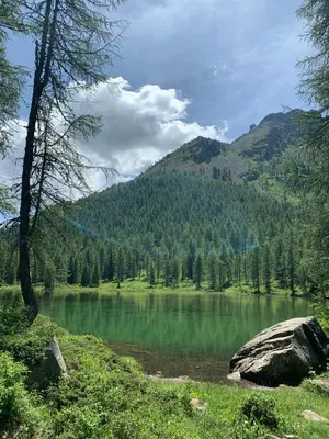 a view of a lake with a mountain in the background at Appartamento San Pellegrino in Passo San Pellegrino