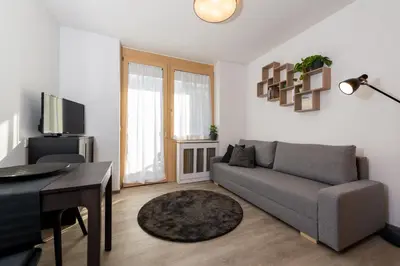 a living room with a couch and a table at Nina • Parchi e Fiume in Bressanone