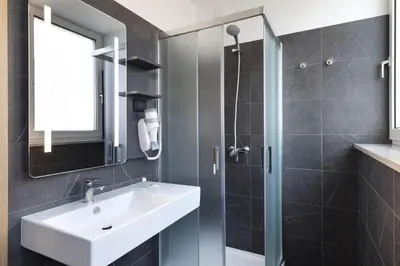 a bathroom with a sink and a shower at B&B Hotel Bolzano in Bolzano