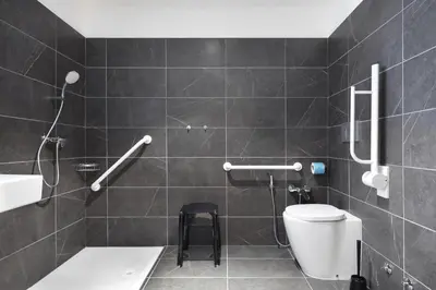 a bathroom with a shower with a toilet and a sink at B&B Hotel Bolzano in Bolzano