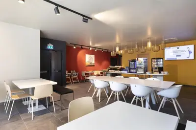 a restaurant with white tables and white chairs at B&B Hotel Bolzano in Bolzano