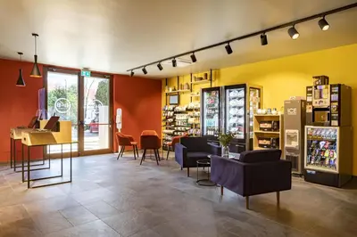 a store with chairs and tables in a room at B&B Hotel Bolzano in Bolzano