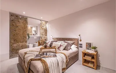 a bedroom with a large bed and a shower at Chalet Luisa in Predazzo
