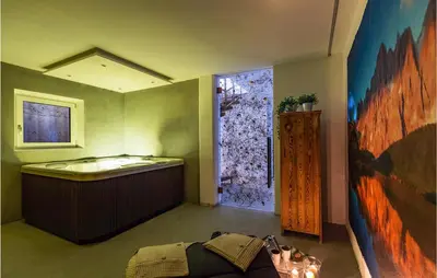 a room with a bath tub and a large window at Chalet Luisa in Predazzo