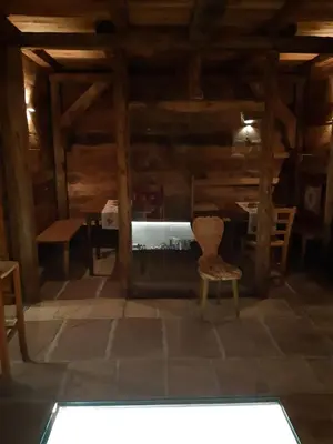 a chair sitting in a room with a table at Locanda Rondolost in Cencenighe