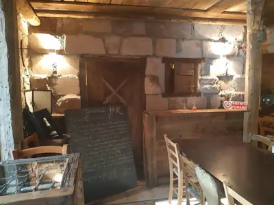 a restaurant with a table and a sign in a room at Locanda Rondolost in Cencenighe