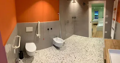 a bathroom with a sink and a toilet and a shower at Albergo Stella in Cavalese