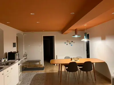 a kitchen with a wooden table and chairs at Albergo Stella in Cavalese