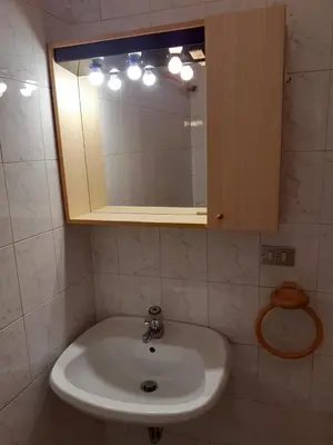 a bathroom with a sink and a mirror at Vacanzemoena - Casa del Moro in Moena
