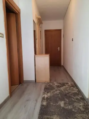 an empty room with a door and a rug at Appartamento Casa Montagna Lory in Pozza di Fassa