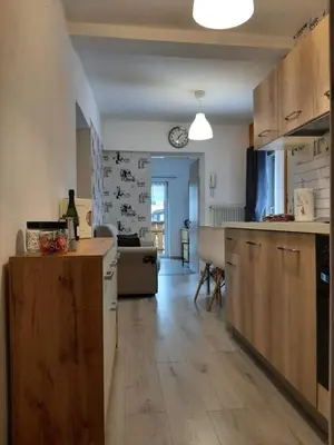 a kitchen with wooden cabinets and a counter top at Appartamento Casa Montagna Lory in Pozza di Fassa