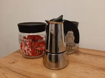 a coffee maker sitting on a wooden shelf with a cup at Appartamento Casa Montagna Lory in Pozza di Fassa