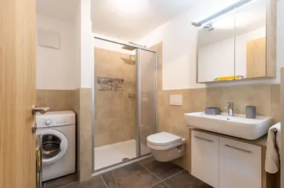 a bathroom with a toilet sink and a shower at Appartments zum Beck in Eggen