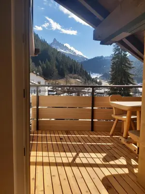 a balcony with a table and a view of the mountains at Appartments zum Beck in Eggen
