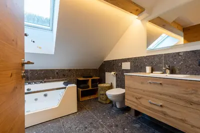 a bathroom with a tub and a sink and a toilet at Appartments zum Beck in Eggen