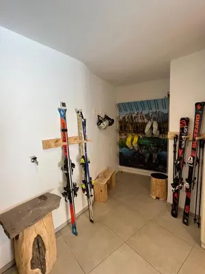 a room with skis on the wall in a room at Appartments zum Beck in Eggen