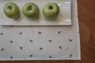 three apples sitting on a plate on a table at Crëp Sella in Colfosco