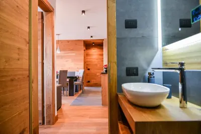 a bathroom with a bowl sink on a wooden counter at San Vigilio di Marebbe - Suite di Montagna in San Vigilio Di Marebbe