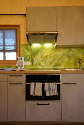 a kitchen with a stove and a sink at NEUE Ferienwohnungen auf dem Gebreitnerhof, Urlaub auf dem Bauernhof in Bressanone