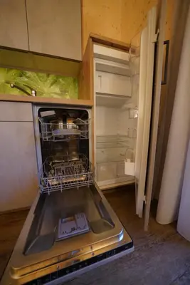 an open refrigerator with a dish rack in it at NEUE Ferienwohnungen auf dem Gebreitnerhof, Urlaub auf dem Bauernhof in Bressanone