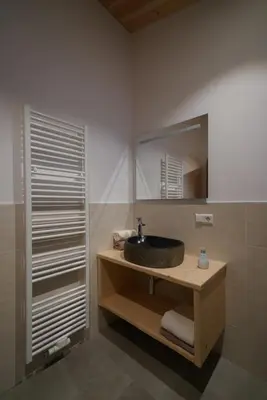 a bathroom with a sink and a mirror at NEUE Ferienwohnungen auf dem Gebreitnerhof, Urlaub auf dem Bauernhof in Bressanone