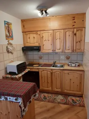a bedroom with a bed with a pink bedspread at Vacanzemoena - Cielo Azzurro, tipologia 4 in Moena