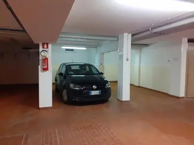a small car parked in an empty parking garage at Vacanzemoena - Cielo Azzurro, tipologia 4 in Moena