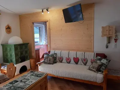a dining room with a table in a wooden room at Vacanzemoena - Cielo Azzurro, tipologia 4 in Moena