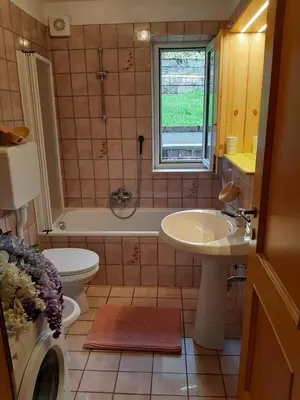 a kitchen with wooden cabinets and a sink at Vacanzemoena - Cielo Azzurro, tipologia 4 in Moena