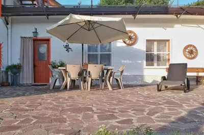 a patio with a table and chairs and an umbrella at Residence Bellavista in Fondo