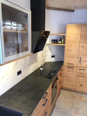a kitchen with a sink and wooden cabinets at Cësa Gredine in Ortisei