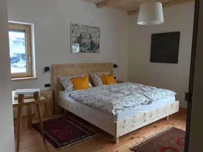 a bedroom with a bed with yellow pillows at Cësa Gredine in Ortisei
