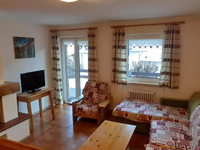 a living room with a couch and a tv at Vacanzemoena - Cielo Azzurro, tipologia 1 in Moena