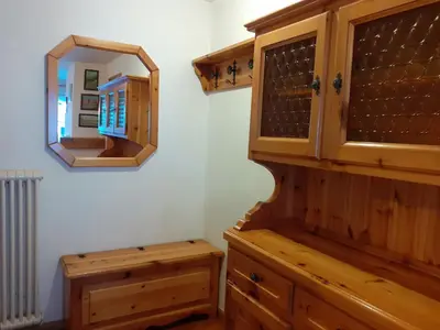 a bathroom with a wooden cabinet and a mirror at Vacanzemoena - Cielo Azzurro, tipologia 1 in Moena