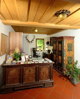 a kitchen with a large wooden desk in a room at Gasthof Thaler in Mezzaselva