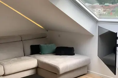 a living room with a couch and a flat screen tv at Apartment Marie in Bolzano