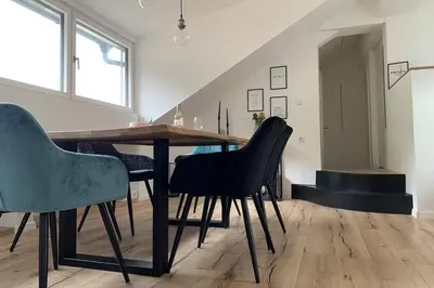 a dining room with a wooden table and chairs at Apartment Marie in Bolzano